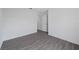 Simple bedroom with gray vinyl plank flooring and a door at 12461 Patsy Ave, Port Charlotte, FL 33981