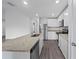 Modern kitchen with white cabinets, granite counters and stainless steel appliances at 12461 Patsy Ave, Port Charlotte, FL 33981