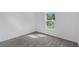 Well-lit bedroom with gray vinyl plank flooring and a window at 12461 Patsy Ave, Port Charlotte, FL 33981