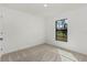 Simple bedroom with neutral carpet and window at 5461 Kempson Ln, Port Charlotte, FL 33981