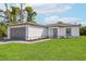 Single-story house with gray garage door and landscaping at 13371 Drysdale Ave, Port Charlotte, FL 33981