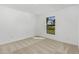 Spacious bedroom with neutral walls and carpet, featuring a large window at 13371 Drysdale Ave, Port Charlotte, FL 33981