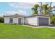 Modern single story home with white exterior and gray garage door at 4600 Kempson Ln, Port Charlotte, FL 33981