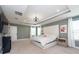 Spacious main bedroom with large bed, plenty of natural light and a tray ceiling at 10194 Gliding Eagle Way, Land O Lakes, FL 34638