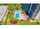 Aerial view of a condo building with a refreshing pool and surrounding lounge area at 2413 Bayshore Blvd # 2004, Tampa, FL 33629