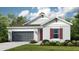 Attractive one-story home with gray siding, red shutters, and a two-car garage at 10571 Piedra Dr, Palmetto, FL 34221