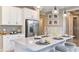 Modern kitchen with white cabinets, large island, stainless steel appliances, and stylish backsplash at 10571 Piedra Dr, Palmetto, FL 34221