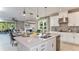 Open concept kitchen featuring a large island, white cabinets, and stainless steel appliances at 10571 Piedra Dr, Palmetto, FL 34221