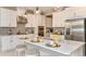 Modern kitchen with white cabinets, stainless steel appliances and a large island at 10571 Piedra Dr, Palmetto, FL 34221