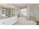 Elegant bathroom with a soaking tub, double vanity, and walk-in shower at 10575 Piedra Dr, Palmetto, FL 34221