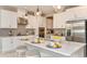 Bright kitchen with white cabinets, stainless steel appliances, and geometric backsplash at 10575 Piedra Dr, Palmetto, FL 34221