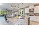 Spacious kitchen with island, white cabinets, and stainless steel appliances at 10575 Piedra Dr, Palmetto, FL 34221