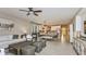 Open living room with white couch, large windows and ceiling fan at 10575 Piedra Dr, Palmetto, FL 34221