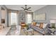 Bright and airy living room featuring a comfortable sofa and large windows at 10575 Piedra Dr, Palmetto, FL 34221