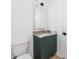 Stylish bathroom with dark green vanity, marble countertops, and a sleek mirror at 1308 E Columbus Dr # 1, Tampa, FL 33605