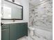 Modern bathroom with green vanity, marble tile, and bathtub at 1308 E Columbus Dr # 1, Tampa, FL 33605