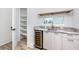 Modern wet bar with wine cooler, marble countertops, and ample shelving at 1308 E Columbus Dr # 1, Tampa, FL 33605