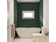 Relaxing bathroom with freestanding soaking tub and dark green tile at 12512 Worchester Ave, Tampa, FL 33624