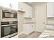 Stainless steel appliances and white shaker cabinets in this kitchen at 32298 Wetland Bird Vw, San Antonio, FL 33576