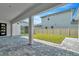 Covered patio overlooks a fenced backyard with grassy lawn at 32298 Wetland Bird Vw, San Antonio, FL 33576