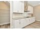 White kitchen cabinets, granite countertops and walk-in pantry at 32298 Wetland Bird Vw, San Antonio, FL 33576