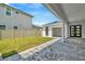 View of backyard, detached garage, and covered patio at 32298 Wetland Bird Vw, San Antonio, FL 33576