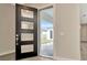 Modern black front door opens to backyard view at 32298 Wetland Bird Vw, San Antonio, FL 33576