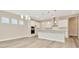 Open concept kitchen with island and view into living area at 32298 Wetland Bird Vw, San Antonio, FL 33576