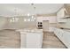 Modern kitchen with white cabinets and granite island at 32298 Wetland Bird Vw, San Antonio, FL 33576