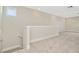 Open loft area with neutral carpet and a half wall at 32298 Wetland Bird Vw, San Antonio, FL 33576