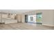 Open concept kitchen with island and modern appliances, leading to backyard at 32298 Wetland Bird Vw, San Antonio, FL 33576