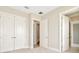 Spacious bedroom with double doors and access to hallway at 32298 Wetland Bird Vw, San Antonio, FL 33576