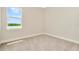 Bright bedroom with neutral walls, carpet, and a window offering a scenic view at 32298 Wetland Bird Vw, San Antonio, FL 33576