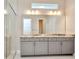 Elegant bathroom with double vanity and large mirror at 32298 Wetland Bird Vw, San Antonio, FL 33576