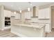 Modern kitchen with white cabinets, granite countertops and island at 32298 Wetland Bird Vw, San Antonio, FL 33576