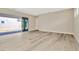 Spacious living room with sliding glass doors and wood-look floors at 32298 Wetland Bird Vw, San Antonio, FL 33576