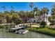 Exterior of waterfront property with a private dock, lift, and jet skis at 814 S Bayside Dr, Tampa, FL 33609