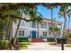 Elegant two-story home featuring a welcoming front porch, manicured landscaping, and a striking blue front door at 814 S Bayside Dr, Tampa, FL 33609