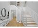 Grand foyer with a modern staircase, high ceilings, hardwood floors, and elegant decor at 814 S Bayside Dr, Tampa, FL 33609
