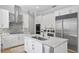 Kitchen features stainless appliances, tile backsplash, custom cabinets, and an island with a sink at 814 S Bayside Dr, Tampa, FL 33609