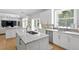 Modern kitchen with white cabinetry, stone countertops, double sinks, and stainless steel appliances at 814 S Bayside Dr, Tampa, FL 33609