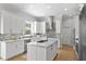Bright, modern kitchen with white cabinetry, marble countertops, and stainless steel appliances at 814 S Bayside Dr, Tampa, FL 33609