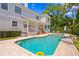 Inviting backyard pool with brick patio, complemented by lush landscaping and a yellow inflatable ring at 814 S Bayside Dr, Tampa, FL 33609