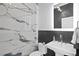 Modern powder room with elegant marble tiling, sleek fixtures, and a minimalist design at 814 S Bayside Dr, Tampa, FL 33609