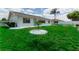 Backyard of home with green lawn, new tree, and white rock accents at 1508 Fort Duquesna Dr, Sun City Center, FL 33573