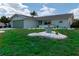 Single story home with light green garage door and nicely landscaped lawn at 1508 Fort Duquesna Dr, Sun City Center, FL 33573