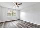 Simple bedroom with wood-look vinyl flooring and a large window at 1508 Fort Duquesna Dr, Sun City Center, FL 33573
