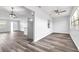 Open living area with wood-look floors and access to kitchen at 1508 Fort Duquesna Dr, Sun City Center, FL 33573
