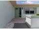 Inviting front entrance with a light green door, stone tile, and landscaping at 1508 Fort Duquesna Dr, Sun City Center, FL 33573