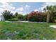 Landscaped backyard with lush greenery and flowering bushes at 1508 Fort Duquesna Dr, Sun City Center, FL 33573